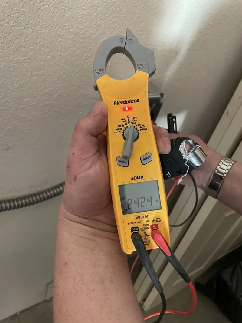 Voltage testing with clamp meter during Recessed Lighting Installation in Wilmore